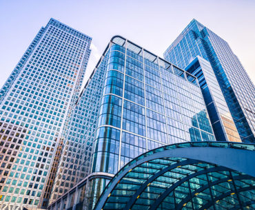 Glass office towers towering toward a blue sky