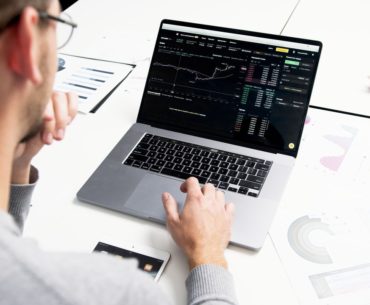 Person looking at market forecast on laptop computer