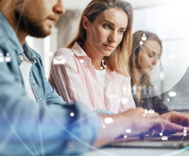 group of young business colleagues using a laptop