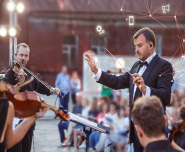 image of conductor and violinists playing, with tech images overlayed
