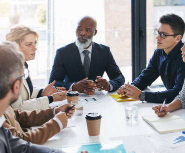 group of professionals talking in a boardroom