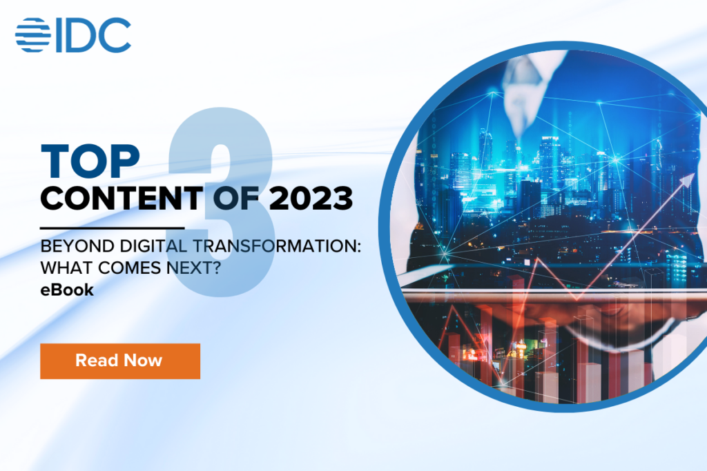 Top 10 content 2023 content 3. Beyond Digital Transformation: What Comes Next? eBook. Man holding laptop with a cityscape coming out.