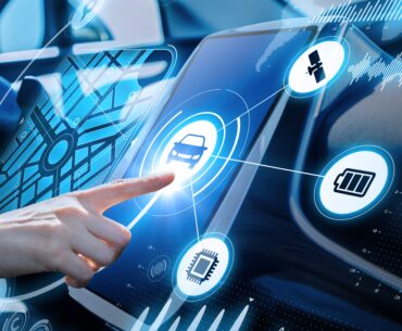 A person's finger touching a futuristic automobile dashboard screen