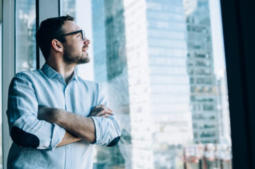 AI Everywhere, Value Nowhere: Why Pricing Innovation Matters Man looking out of a window