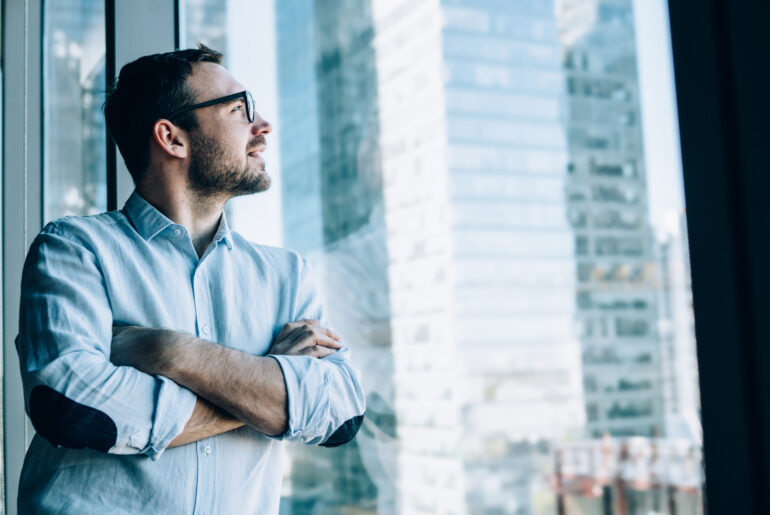 AI Everywhere, Value Nowhere: Why Pricing Innovation Matters Man looking out of a window