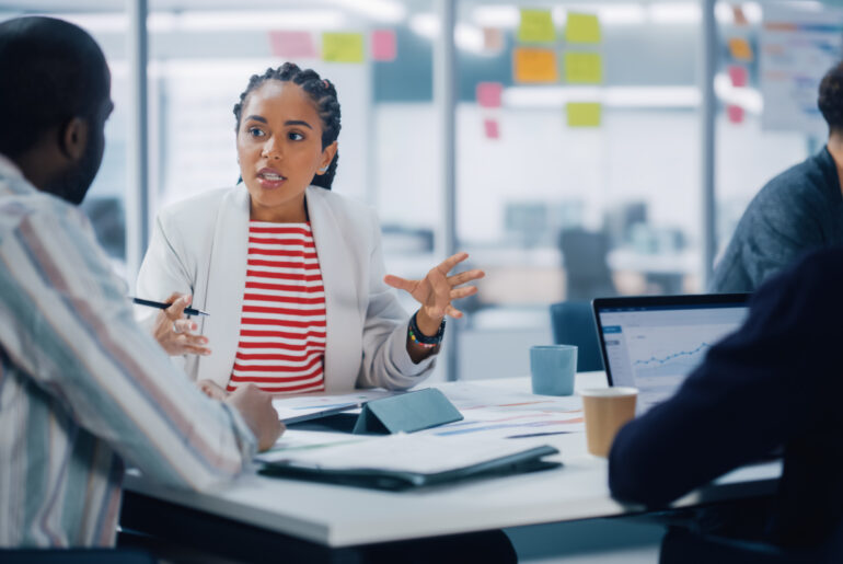 Business professionals collaborating on AI-driven innovation strategies in a modern office.